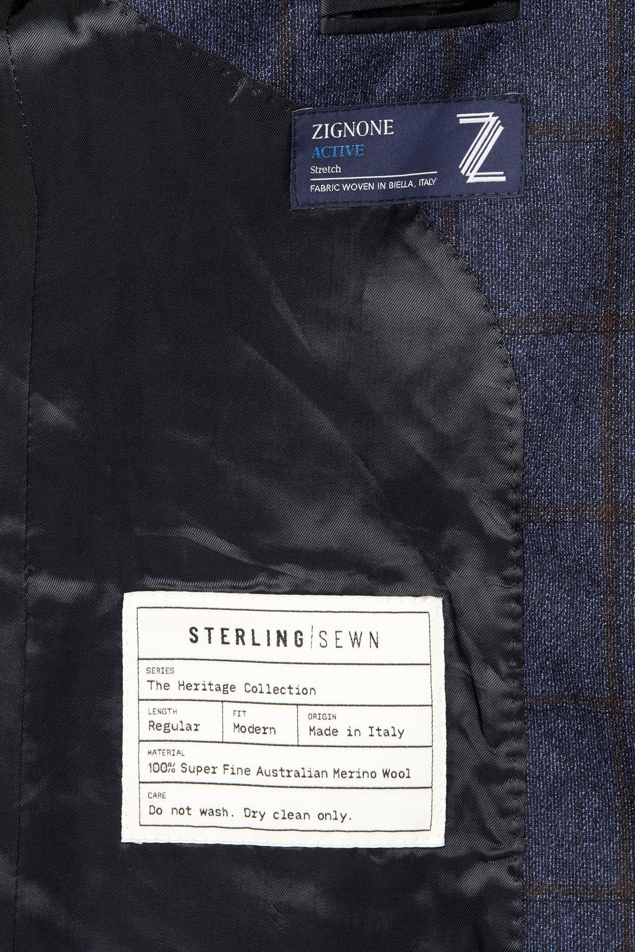 Close-up of textured navy fabric, black lining and the Sterling Sewn Heritage Collection label