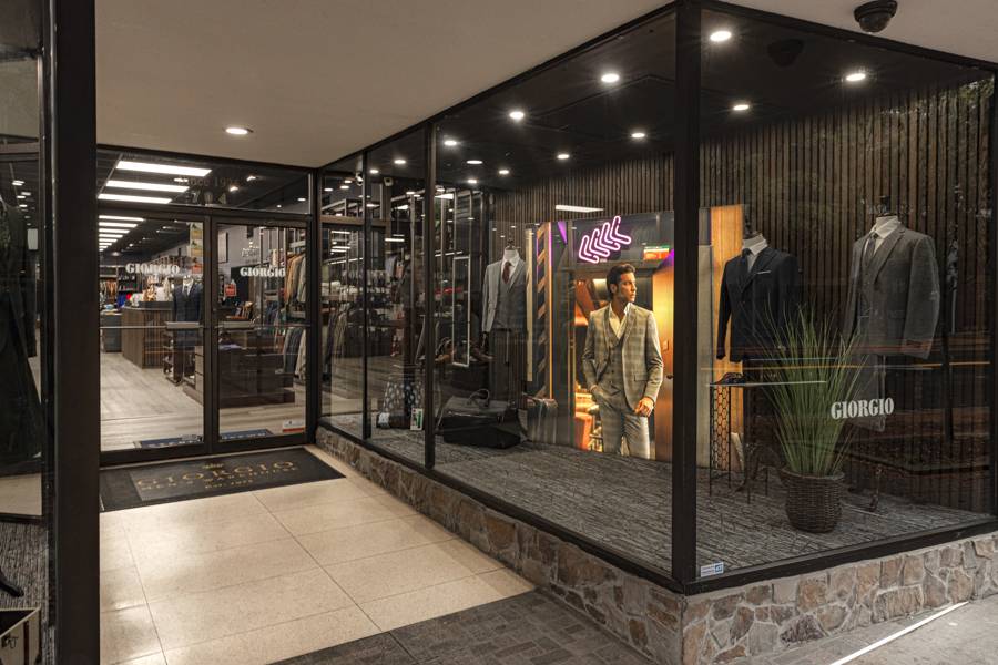 The glass storefront of Giorgio Men’s Wear on Market Street in Chattanooga
