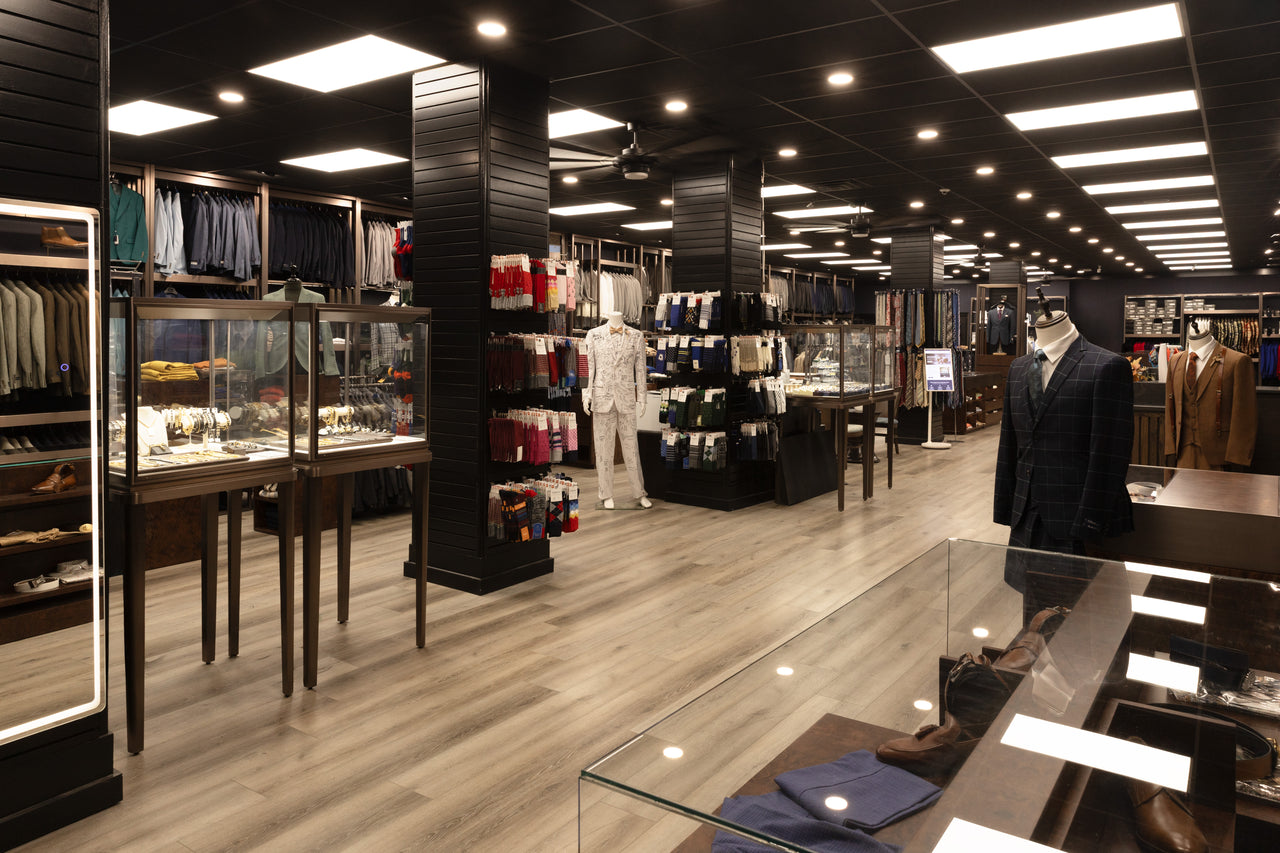 Wide view of Giorgio Men’s Wear with accessory displays, suit racks and mannequins