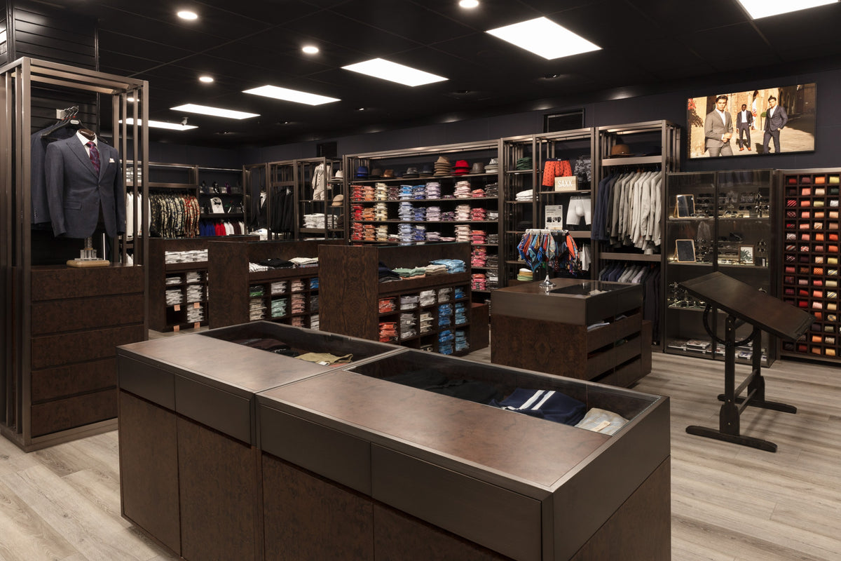 Inside Giorgio Men’s Wear in Chattanooga: a suited mannequin, shirt shelves and display tables