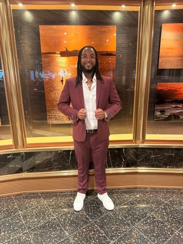 Customer Kylon W. wearing the Burgundy 2 Button Suit with white sneakers